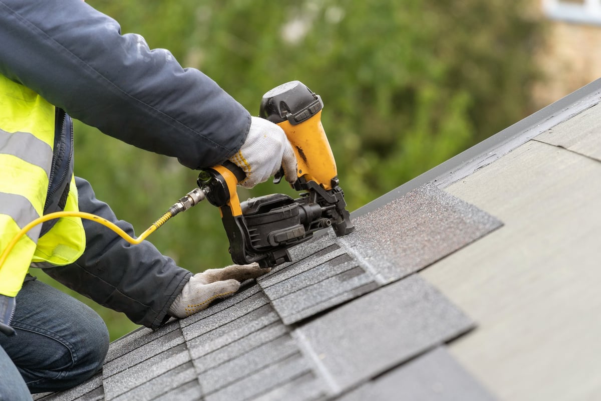 Professional roofing crew performing a complete roof replacement