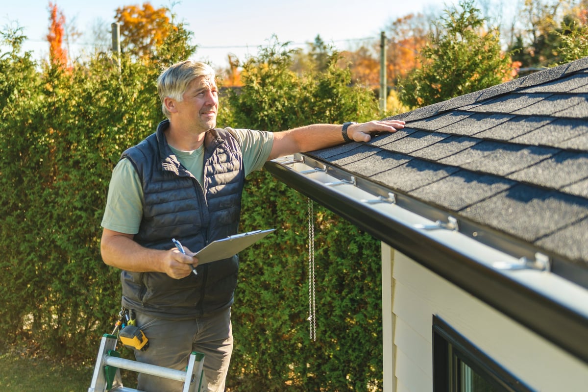 Roofer repairing damaged roofing materials