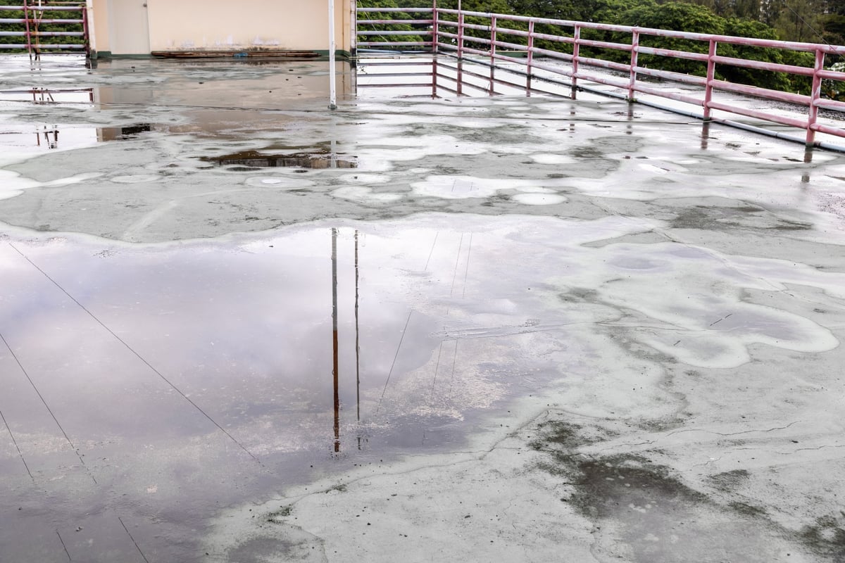 Roofer investigating a roof leak source